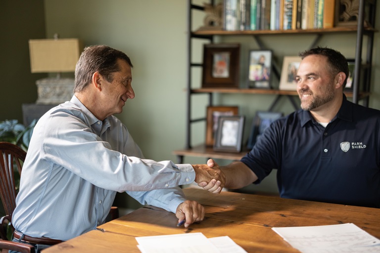 Nathan Kinnaman shaking hands with client